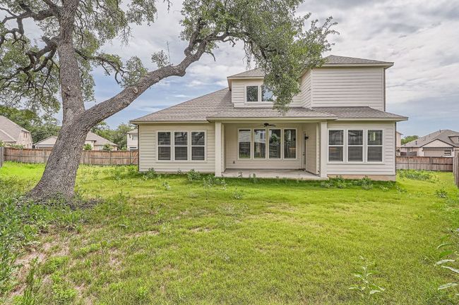 Rear view of property with a patio area, ceiling fan, and roof with shingles | Image 28