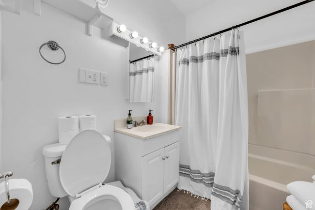 Bathroom featuring toilet, vanity, and shower / tub combo with curtain | Image 16