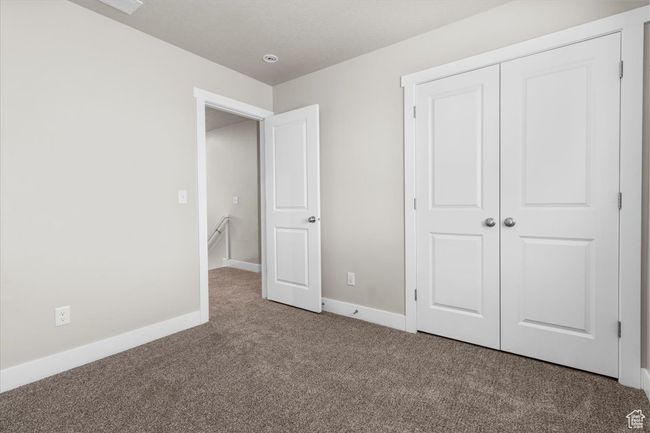 Unfurnished bedroom featuring carpet flooring, a closet, and baseboards | Image 28