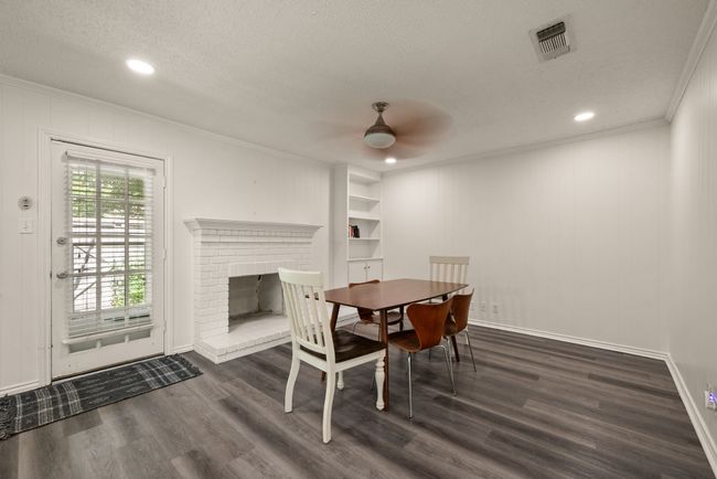 Dining area with visible vents, ornamental molding, dark wood-type flooring, a textured ceiling, and ceiling fan | Image 11