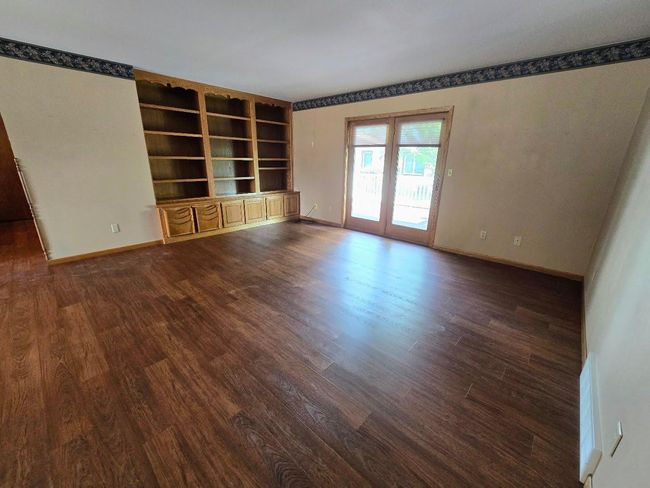 Living room area with patio doors to the north deck area | Image 20