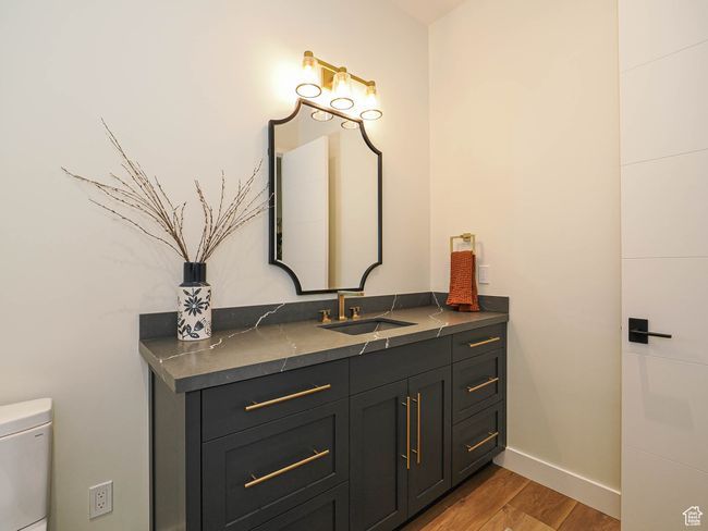 Half bath featuring vanity and wood finished floors | Image 87