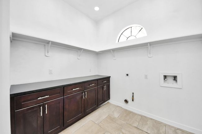 Utility room with lots of cabinet space and hidden storage room | Image 22