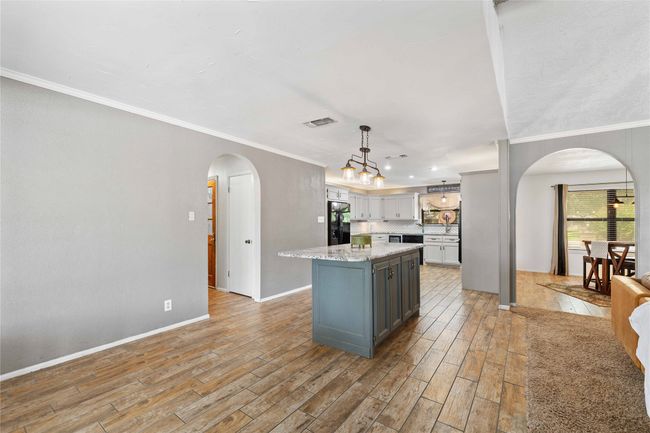 Kitchen featuring dishwasher, wine cooler, island, and open floor plan | Image 14