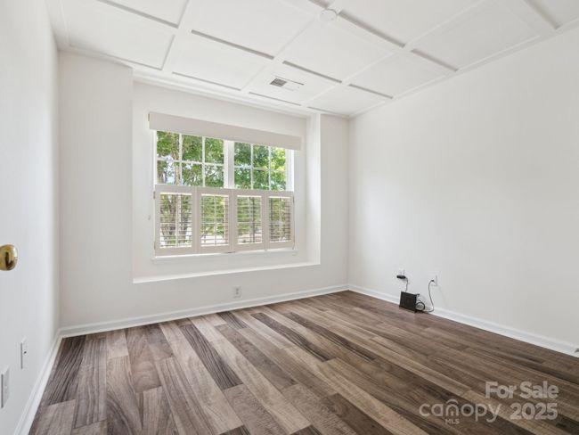 Guest Bedroom has laminatel flooring and a coffered ceiling with a great view of the neighborhood pool. | Image 22