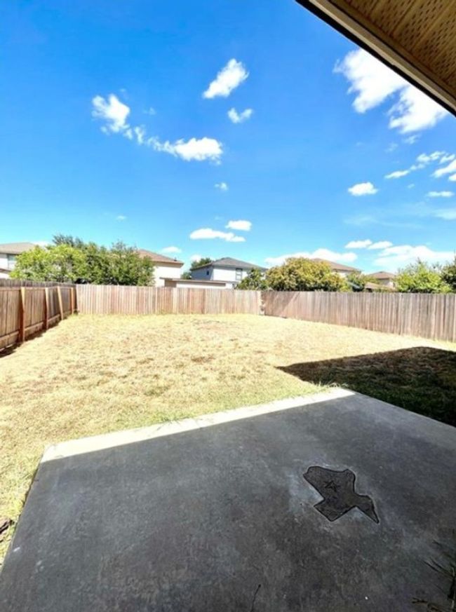 Fenced backyard featuring a patio | Image 17