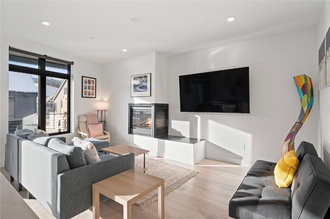 Living room with light wood-type flooring | Image 8