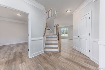 Stairs featuring light hardwood / wood-style floors and crown molding | Image 3