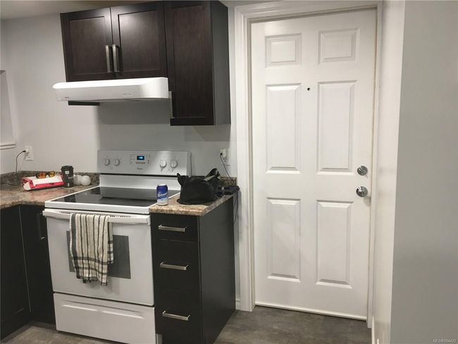 Kitchen featuring light countertops, white electric range oven, and extractor fan | Image 29