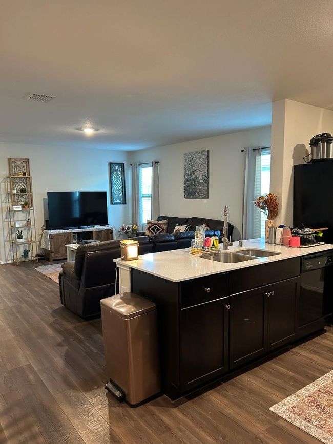 Living area features wood-plank vinyl flooring, recessed lighting and lots of natural light. | Image 7