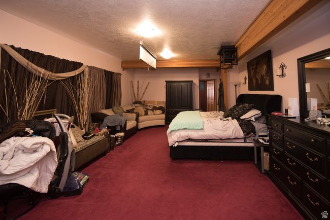 Bedroom featuring carpet flooring and a textured ceiling | Image 60