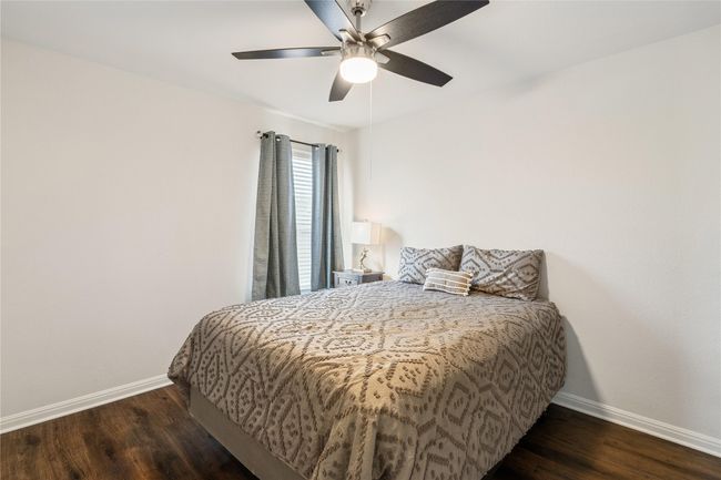 Bedroom featuring baseboards, ceiling fan, and wood finished floors | Image 7