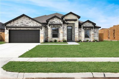 View of front facade with a front yard and a garage | Image 1