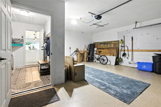 Converted to a 1-bay garage to create a dedicated indoor laundry room—a rare and valuable upgrade in Florida. Still offers plenty of space for storage or a workshop setup and parking for a car! also has a 220V outlet waiting for an EV Charger (Level 2 charging compatible) | Image 46