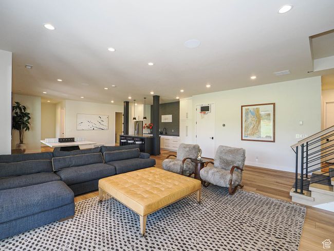 Living area featuring light wood-style floors, recessed lighting, and stairs | Image 68