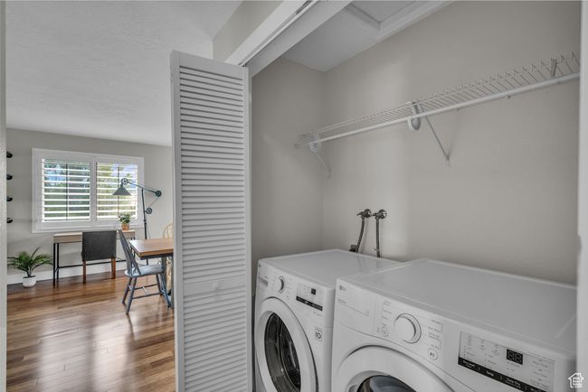 Laundry room with washer and dryer, wood finished floors, and a desk | Image 17