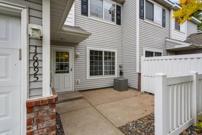 Step into relaxation featuring a semi-private front porch, perfect for unwinding outdoors. This inviting space offers a blend of privacy and neighborhood charm, with enough seclusion for morning coffees, reading, or enjoying a quiet moment. | Image 2