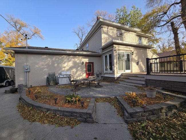 Enjoy a sitting around a fire around this beautifully landscaped patio-Red door to attached garage | Image 49