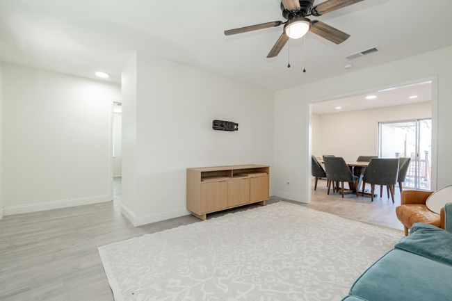 Living room featuring light wood-style flooring, recessed lighting, and ceiling fan | Image 5