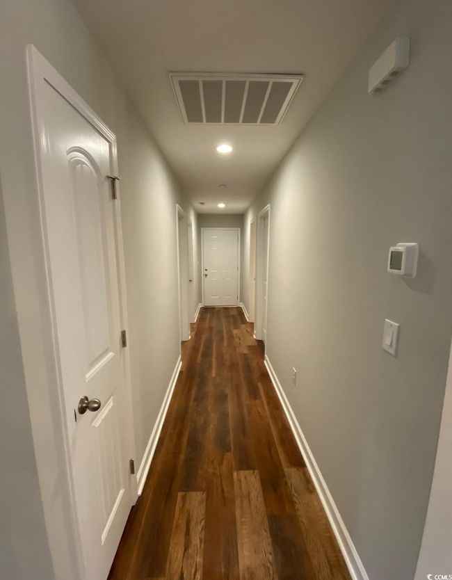 Hallway with dark wood-style flooring, baseboards, and recessed lighting | Image 12