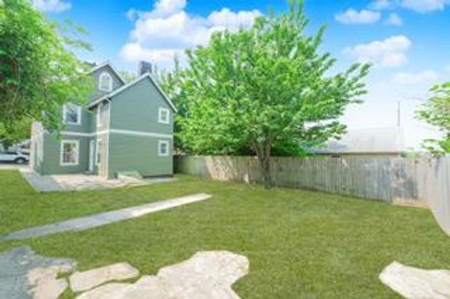 Fenced backyard with a patio area | Image 17