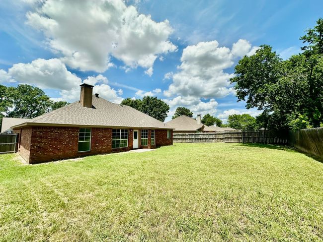 View of fenced backyard | Image 25