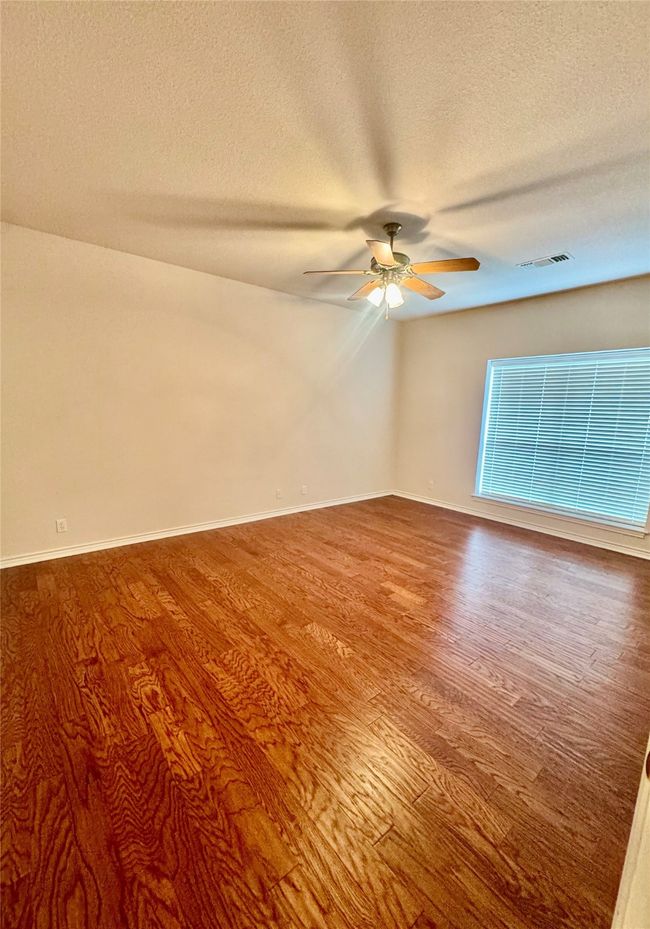 Two generously sized secondary bedrooms in split floorplan, both with hardwood flooring | Image 10