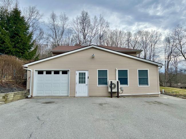 View of front of house with a garage, driveway, and ac unit | Image 21