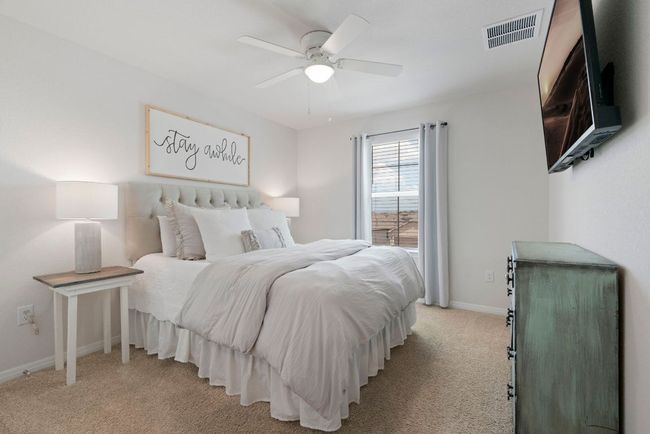 Bedroom with light carpet and a ceiling fan | Image 27