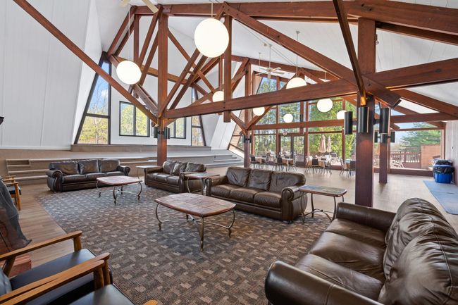 Living room with beamed ceiling, wood finished floors, and high vaulted ceiling | Image 15