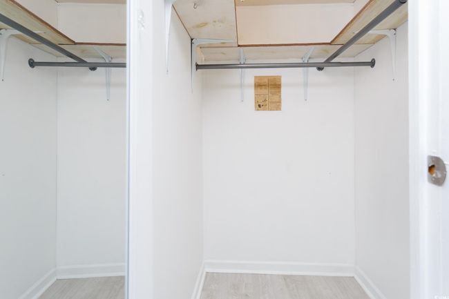 Walk in closet with wood finished floors | Image 21