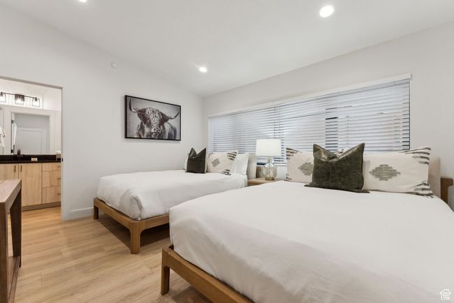 Bedroom featuring light hardwood / wood-style floors and lofted ceiling | Image 28