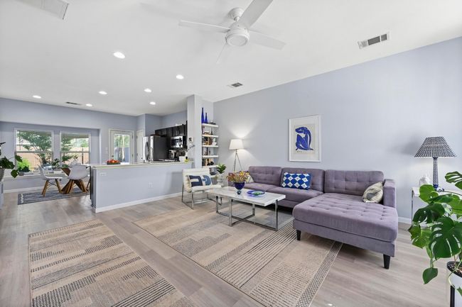 Living area featuring light wood-style floors, visible vents, and recessed lighting | Image 8