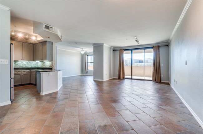 Kitchen with stainless steel refrigerator, ceiling fan, ornamental molding, and backsplash | Image 29