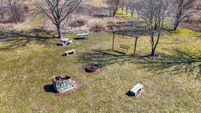 Towards the back of the property there is a firepit, swing and the beginnings of a playhouse. | Image 50