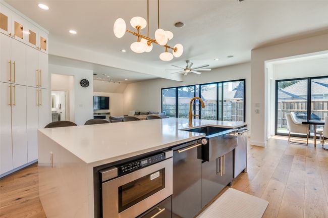Kitchen with hanging light fixtures, recessed lighting, light wood-type flooring, and ceiling fan with notable chandelier | Image 8