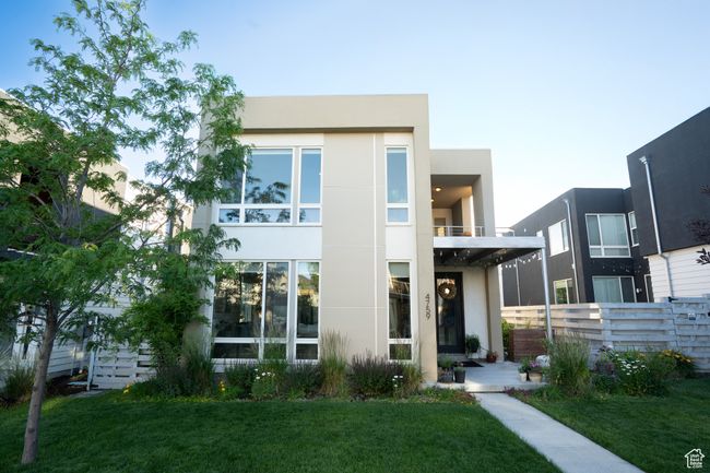 Modern home featuring stucco siding and a balcony | Image 35