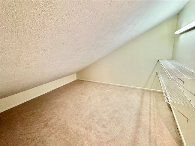 Second floor storage room features lighting and shelving for storage. | Image 24
