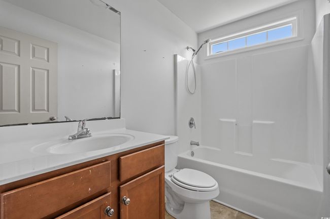 Bathroom with vanity, toilet, and shower / bathtub combination | Image 35
