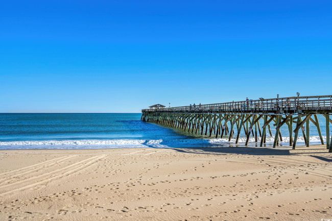 Dock area featuring a pier and view of water and beach | Image 38