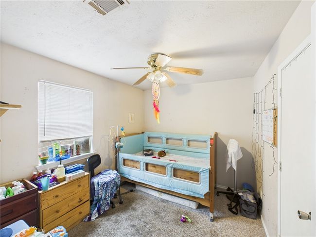 Carpeted bedroom featuring a ceiling fan | Image 10