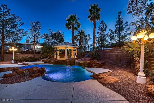 View of pool with a fenced in pool, a fenced backyard, and a gazebo | Image 6