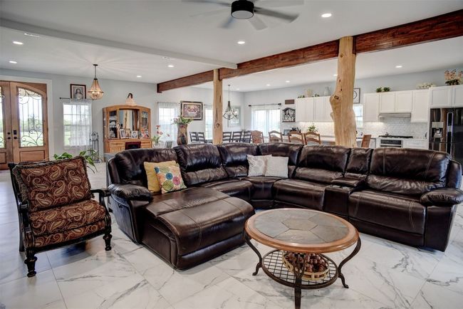 Huge wood beams and cedar tree trunks used for support in this home! | Image 10