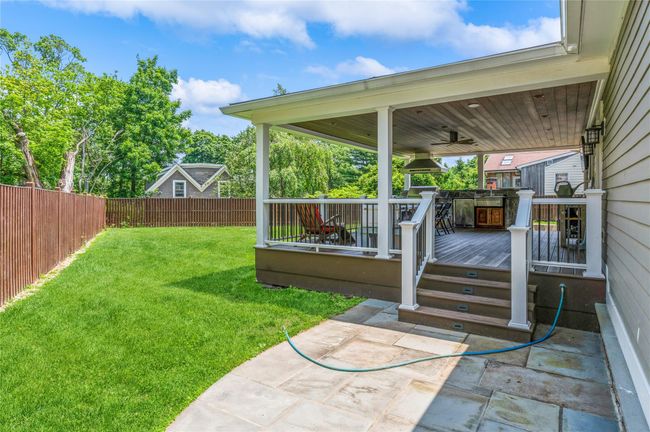 Fenced backyard with a deck and a ceiling fan | Image 23
