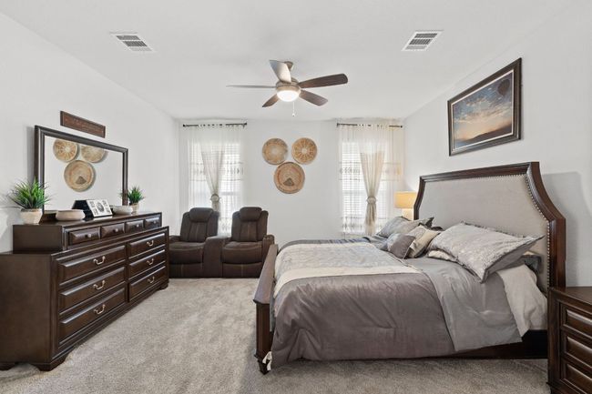 Bedroom with light colored carpet and ceiling fan | Image 18