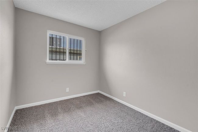 Carpeted spare room featuring baseboards and a textured ceiling | Image 28