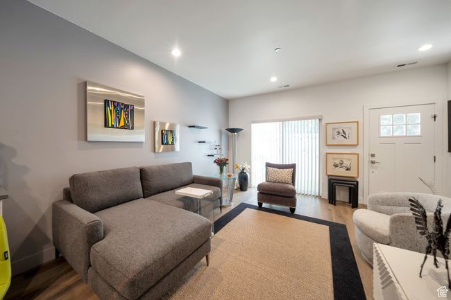 Living area with wood finished floors and recessed lighting | Image 4