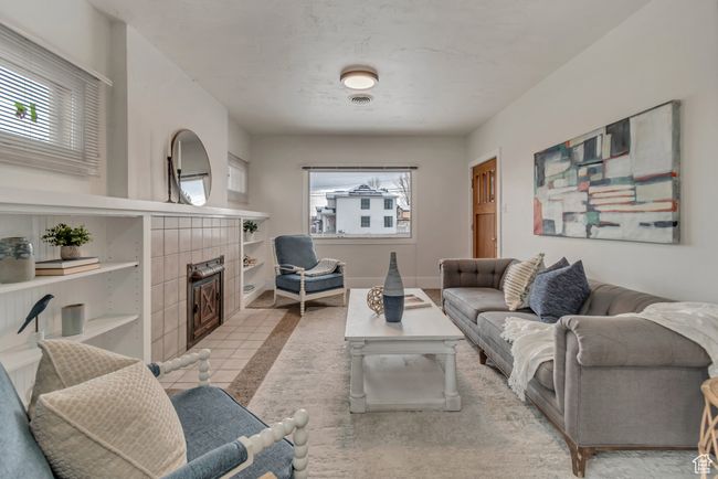 Living room featuring a tiled fireplace and baseboards | Image 9