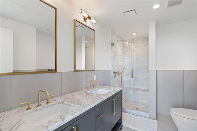Full bathroom with toilet, visible vents, and a sink | Image 17