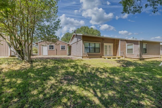 Back of property featuring a yard, french doors, and an outbuilding | Image 39